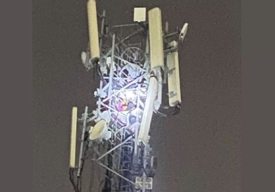 A young man climbed a mobile tower